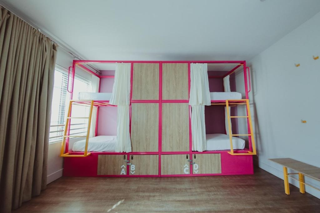 A room with bunk beds and curtains