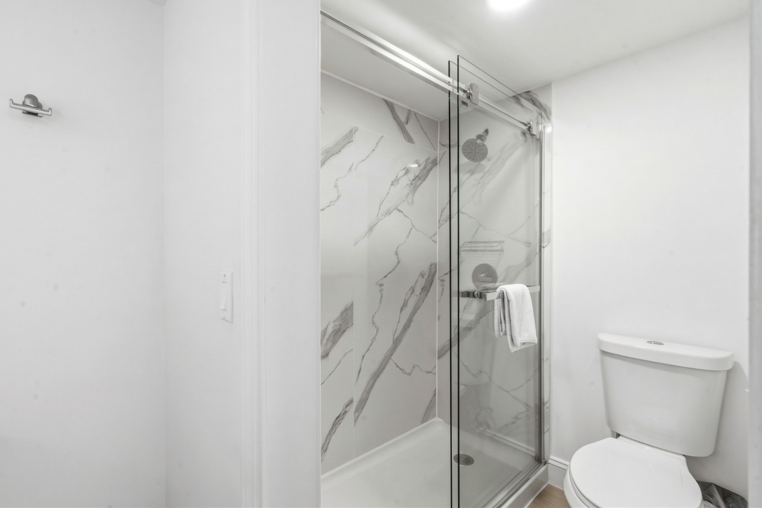 A bathroom with a shower and toilet