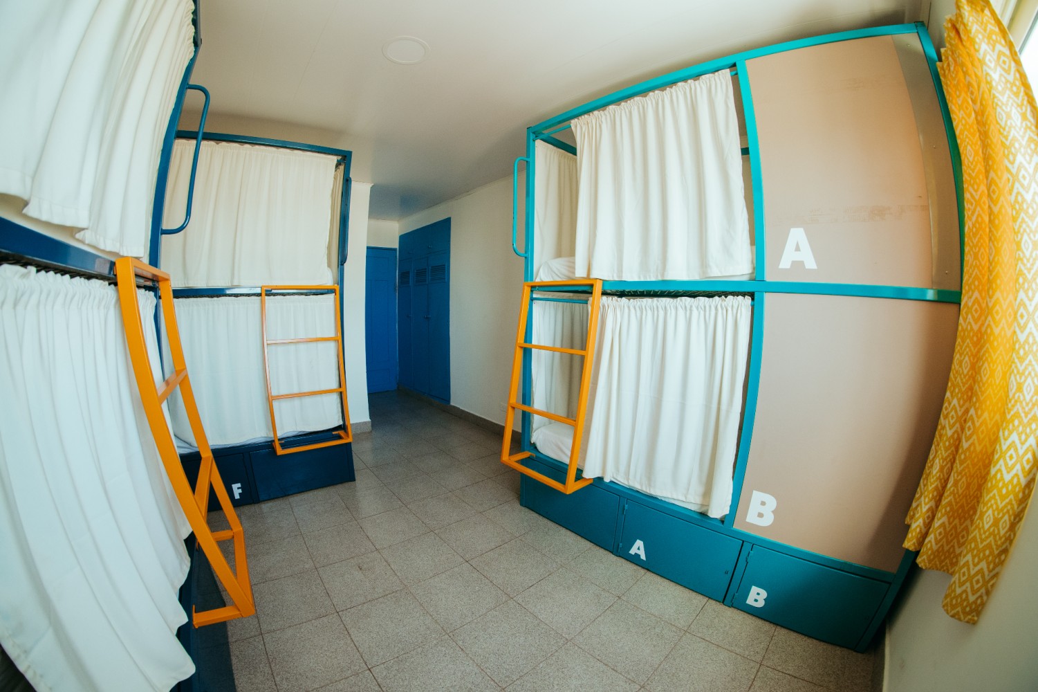A shared room with bunk beds and storage